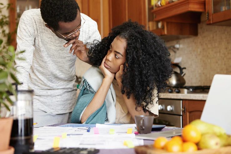 Lady and gent at a table trying to understand work placed on the table